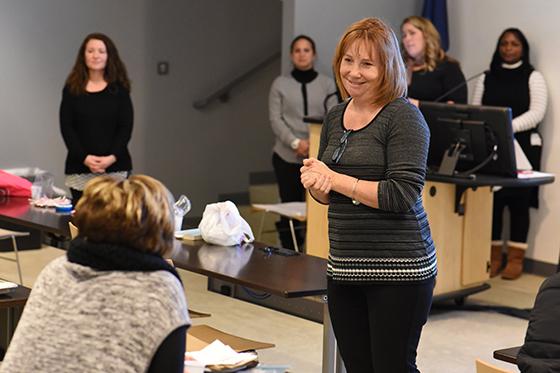 Photo of a professor listening to a student's question during a lecture